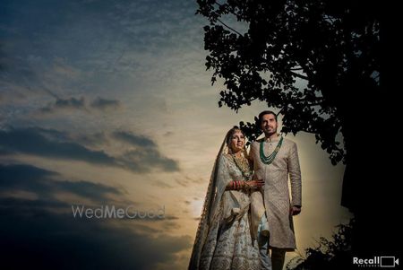 Photo of wedding day couple sunset shot with both wearing matching outfits