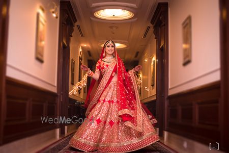 Photo of Bridal portrait twirling in red lehenga