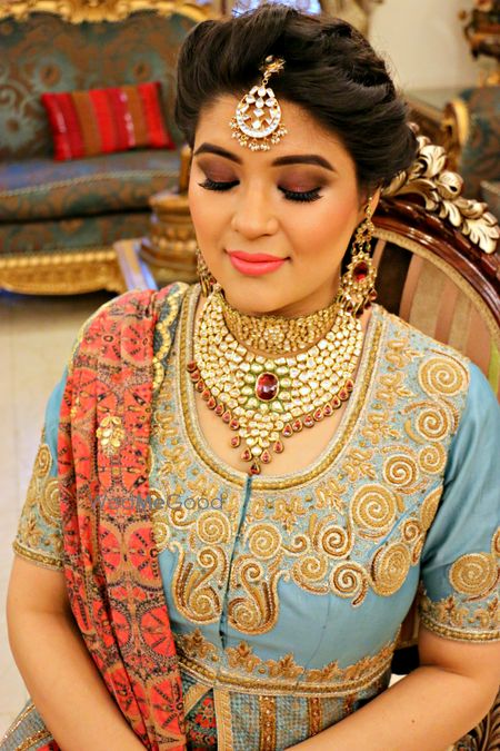 Photo of Bride getting makeup done with bronze smokey eyes