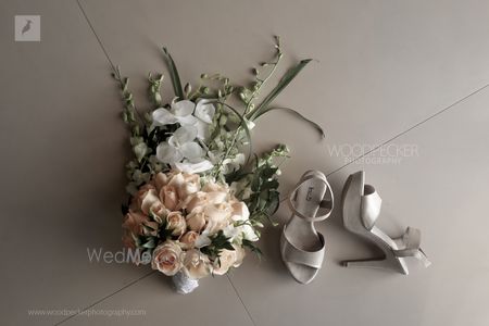 Photo of A unique bridal bouquet and a stunning pair of bridal shoes.