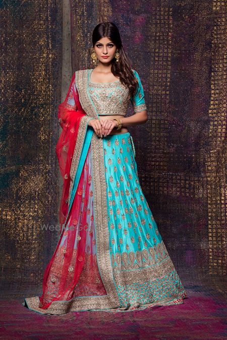 Photo of Aqua lehenga with gold motifs and red dupatta