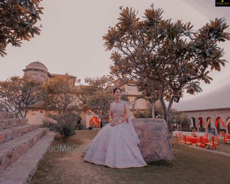 Photo of Bride wearing a pastel pink lehenga.