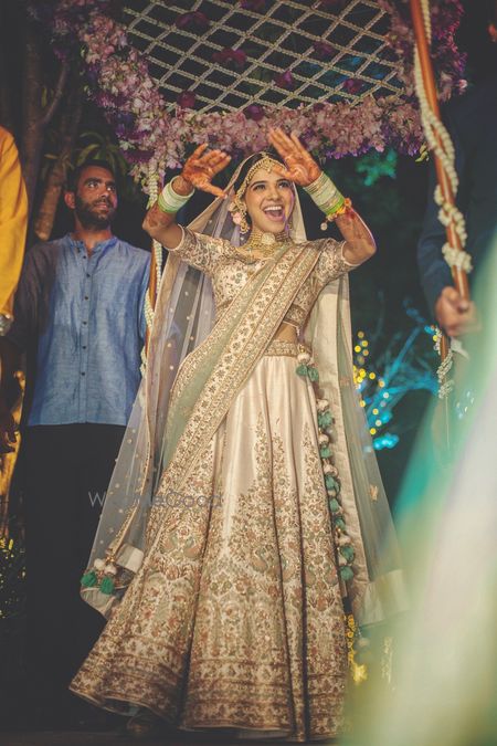 Photo of Dancing bride in ivory lehenga