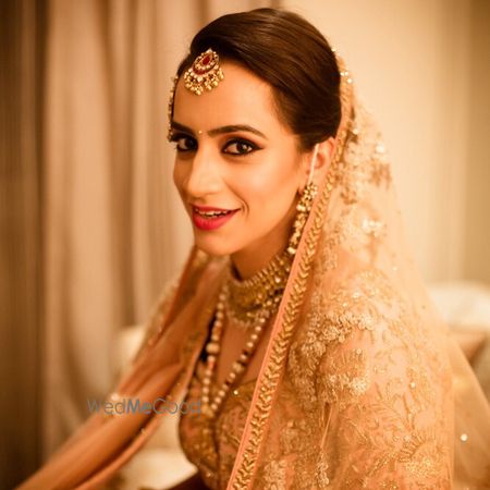 Photo of Bridal look in peach lehenga