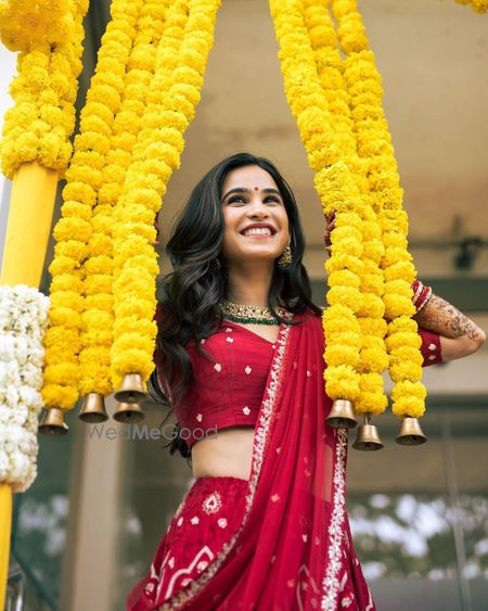 Photo of Bride posing with floral strings.