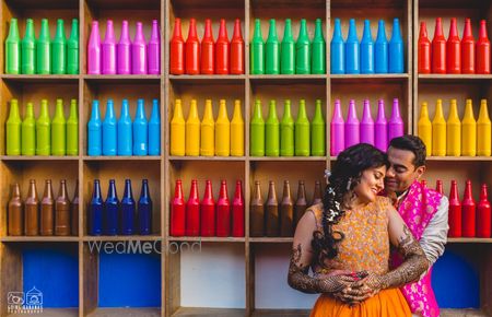 Photo of Colourful painted bottles as backdrop for mehendi