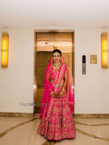 Photo of Bright pink bridal lehenga with floral embroidery