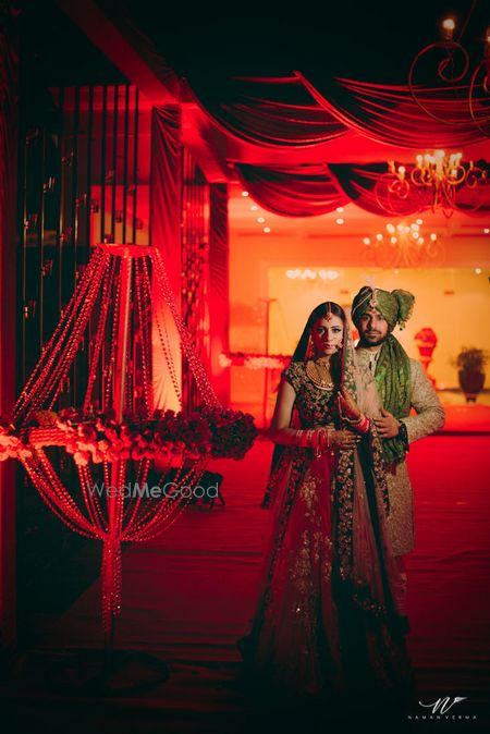 Photo of Glam couple portrait shoot with red decor