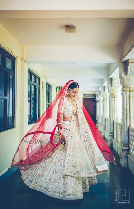 Photo of Twirling bride in white and gold