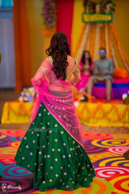 Photo of Mehendi lehengas in green with pink dupatta