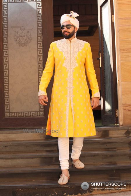 Photo of Groom in bright yellow and white sherwani