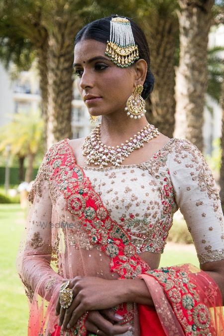 Photo of Embellished white blouse with floral motifs