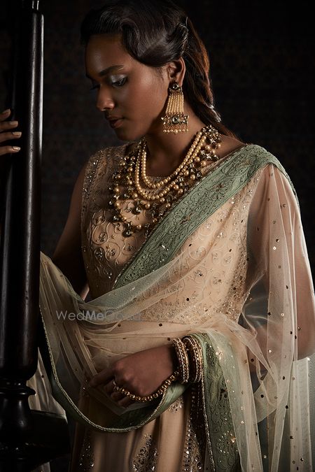 Photo of Dusky bride wearing olive green and beige lehenga