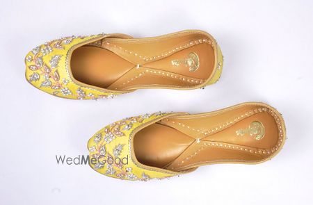 Photo of yellow juttis with pearl work