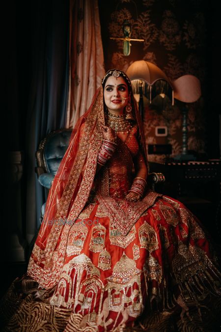 Photo of A bride wearing a traditional red lehenga