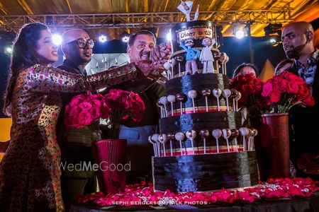 Photo of Quirky black wedding cake with lollipops