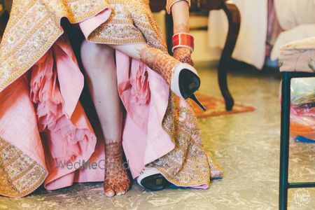 Photo of Lehenga with can can and bride wearing shoes