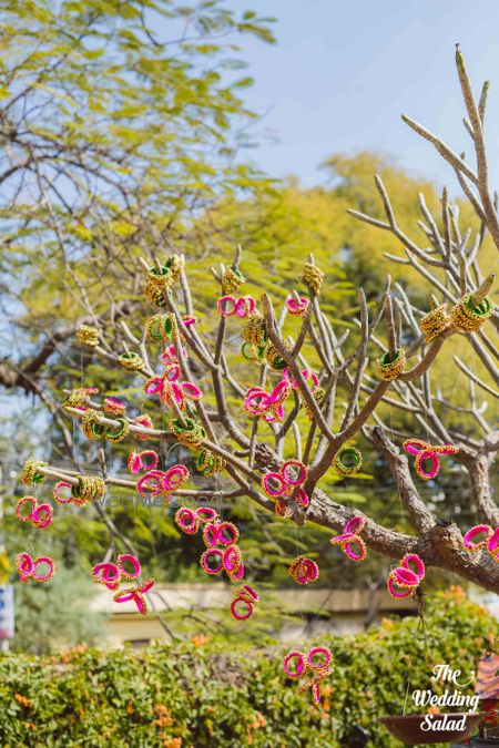 Photo of  Colorful Bangles on tree branches in mehendi decor