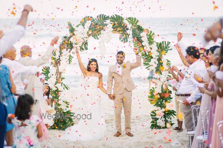 Photo of A Christian couple right after their wedding ceremony at a beach