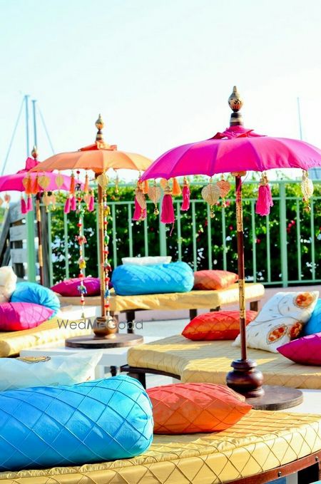 Photo of Mehendi seating idea with umbrellas with tassels