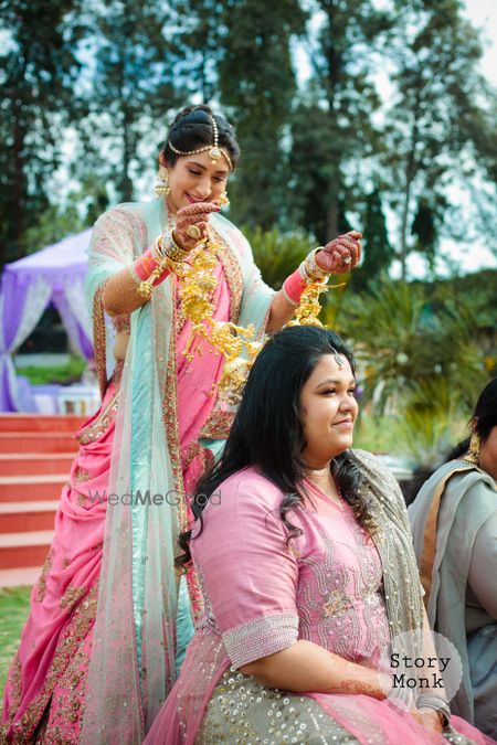 Photo of Bride with bridesmaid dropping kaleere