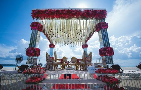 Photo of Red and white floral mandap decor