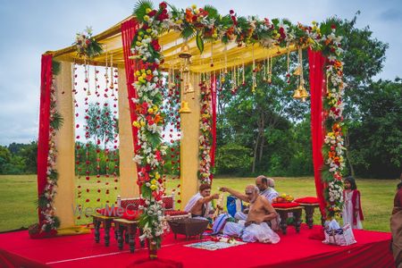 Photo of Red open air mandap with temple bells