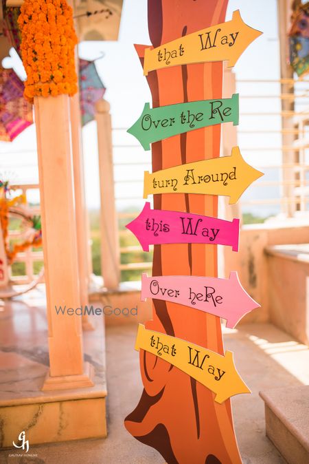 Photo of Mehendi or wedding decor with cute direction boards