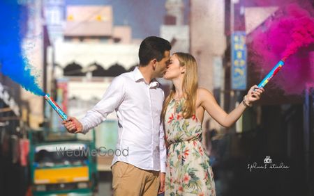 Photo of Pre wedding shoot with kissing couple and smoke sticks