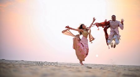 Photo of Crazy couple jumping shot after wedding