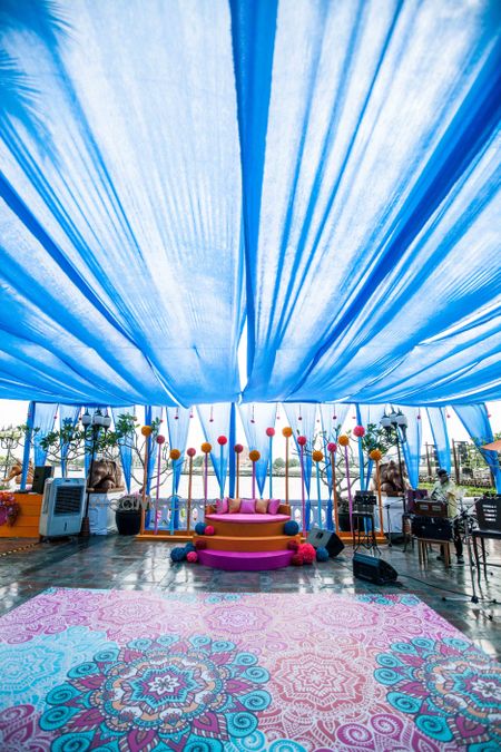 Photo of Mehendi decor with printed dance floor in blue and pink