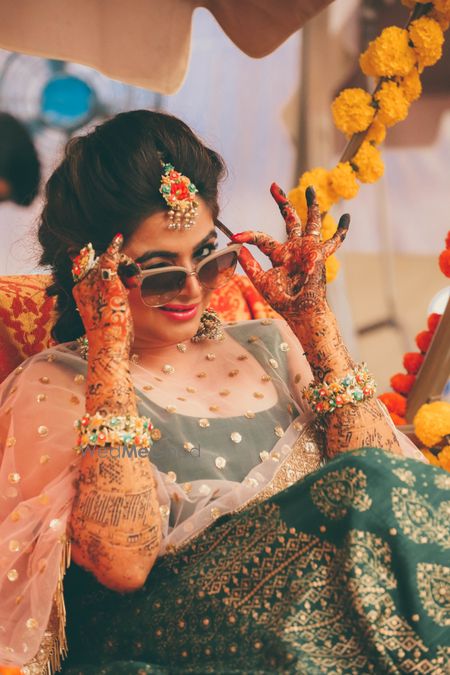 Photo of Bridal portrait on mehendi wearing sunglasses