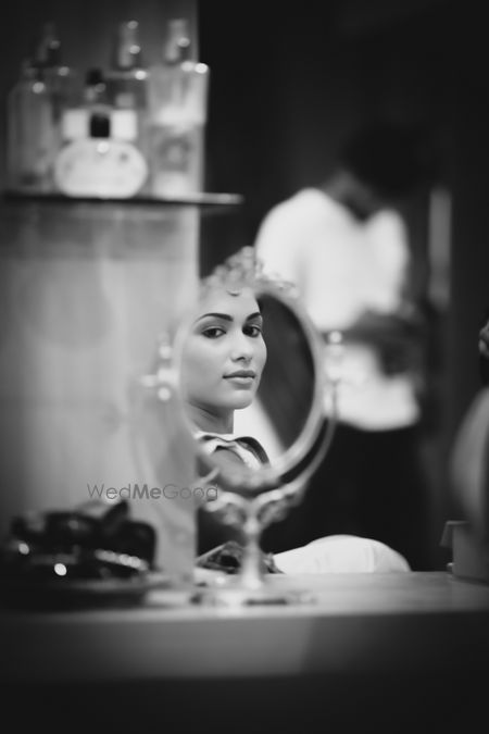 Photo of bride looking in mirror