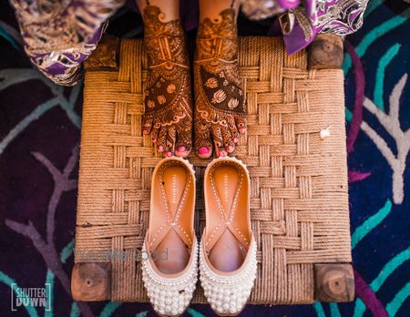 Photo of Mehendi bridal feet and juttis with pearls