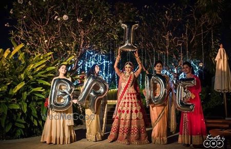 Photo of Bridal portrait with foil balloons and bridesmaids