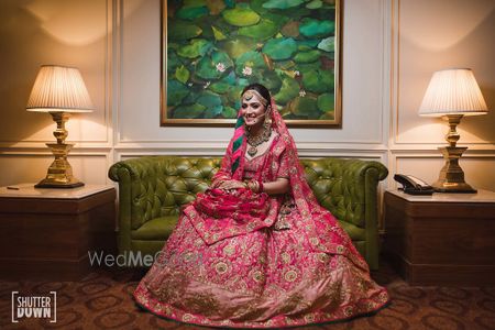 Photo of Bright pink bridal lehenga with contrasting inner dupatta lining