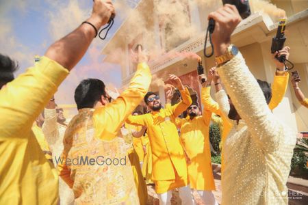 Photo of Fun groom entry for the haldi with groomsmen and smoke bombs