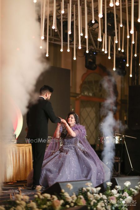 Photo of Cute shot of the bride on her knees for the ring exchange on the engagement event