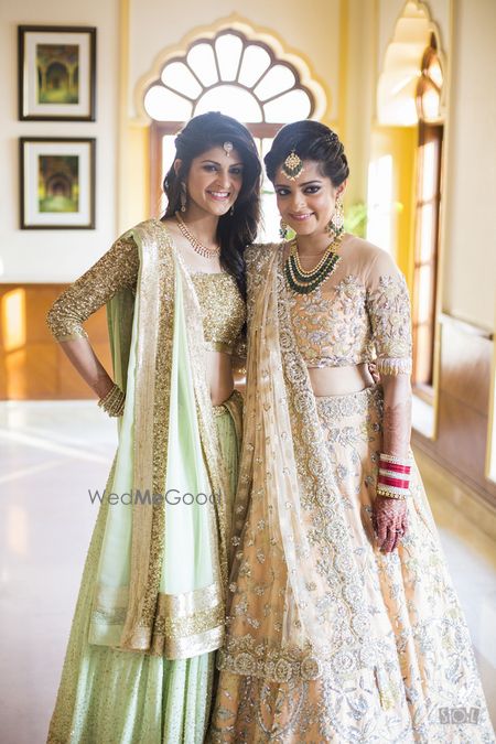 Photo of Bride and sister in girly pastel lehengas