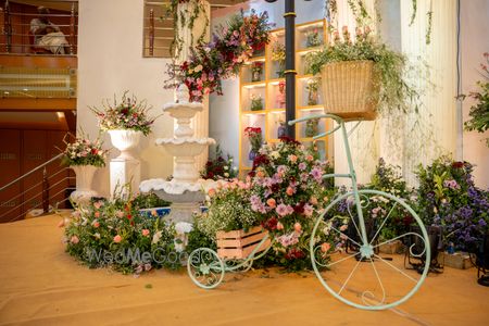 Photo of Gorgeous floral arrangement on stage with a vintage style floral bicycle