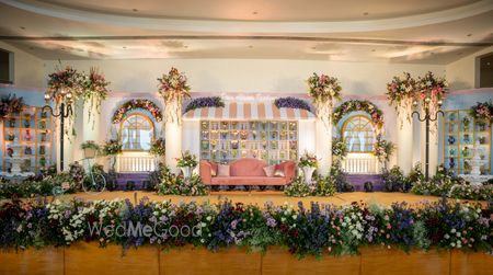 Photo of Lovely stage decor in purple and lilac for an indoor wedding event