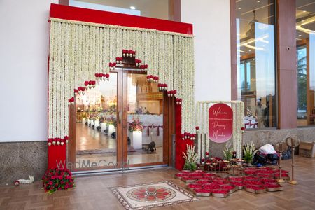 Photo of Lovely white and red floral entrance decor for a wedding entry