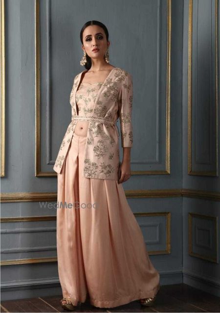 Photo of Light peach lehenga with jacket and waist belt