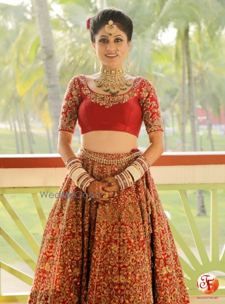 Photo of Getting ready shot with bride in blouse and lehenga