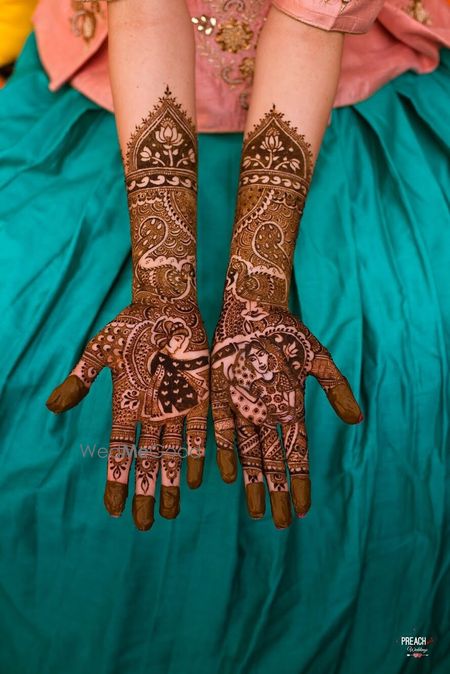 Photo of Bride and groom portrait half and half mehendi