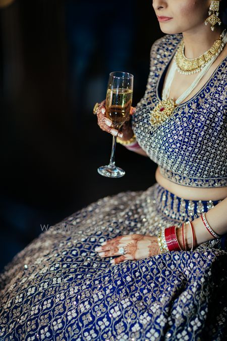 Photo of Bride getting ready shot having champagne