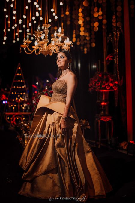 Photo of Ruffled off shoulder cocktail gown in gold