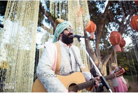 Photo of Unique idea as groom sings for bridal entry