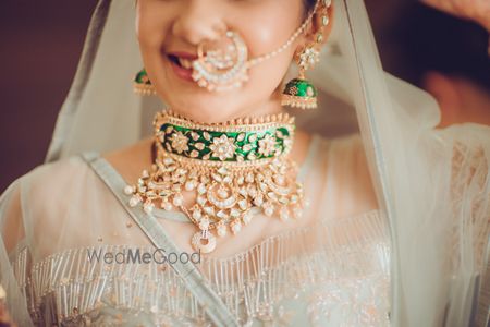 Photo of Indian bride wearing gold and green emerald choker for wedding