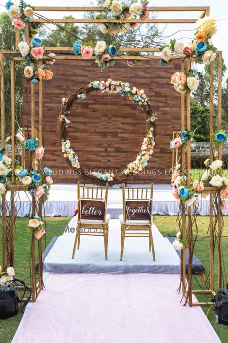 Photo of Floral wreath and couple chairs with simple mandap